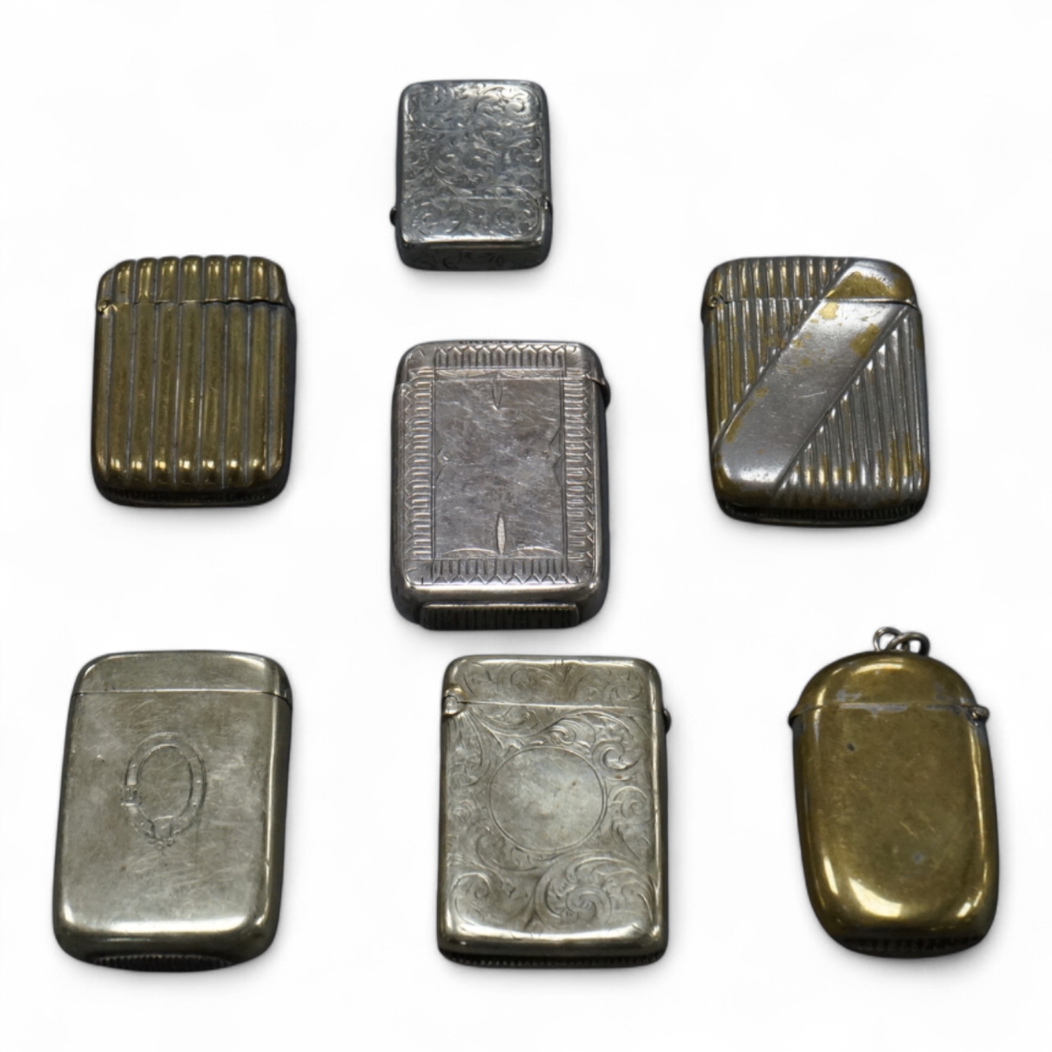 Seven base metal vesta cases, largest 6cm high